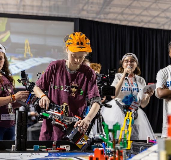 young people operating LEGO robot