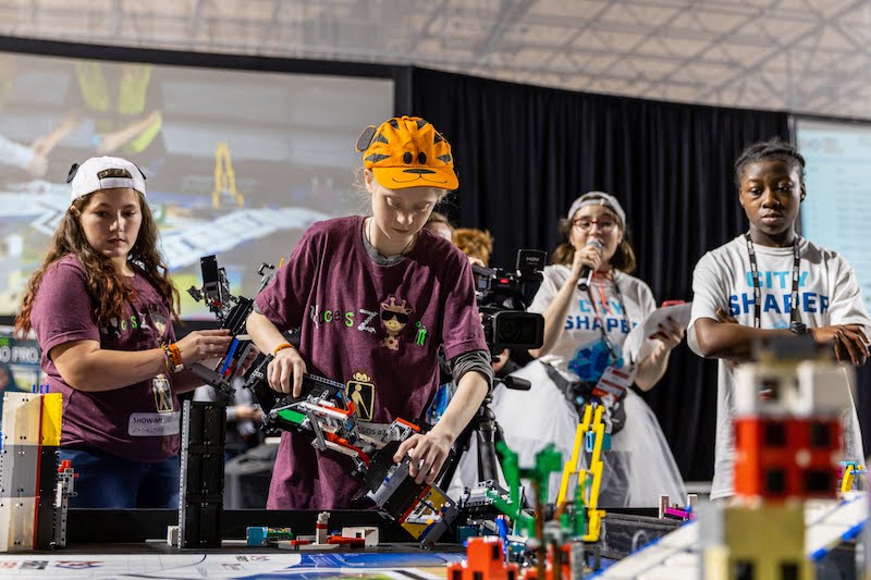 young people operating LEGO robot